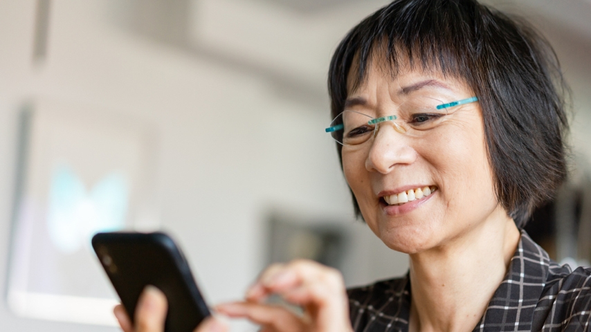 Person holding a mobile device and tapping the screen