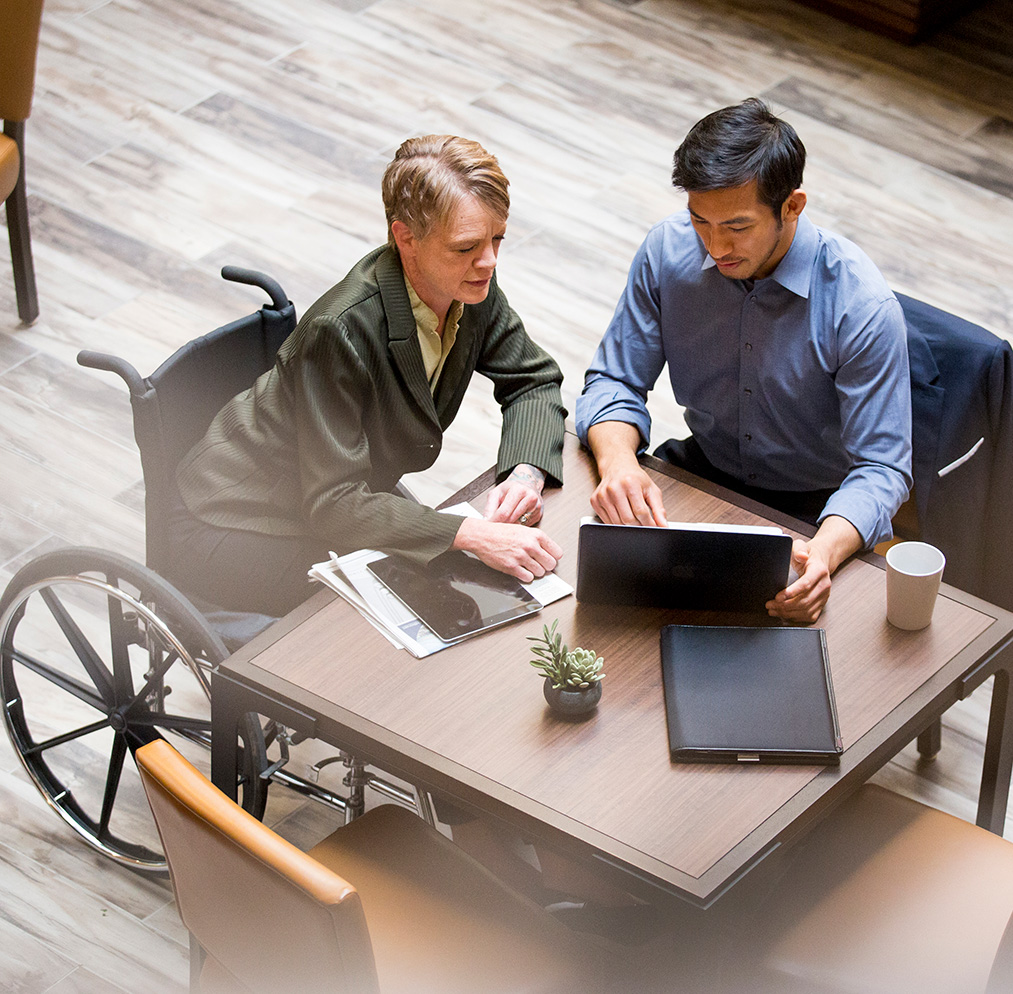 Man in wheelchair going over investments