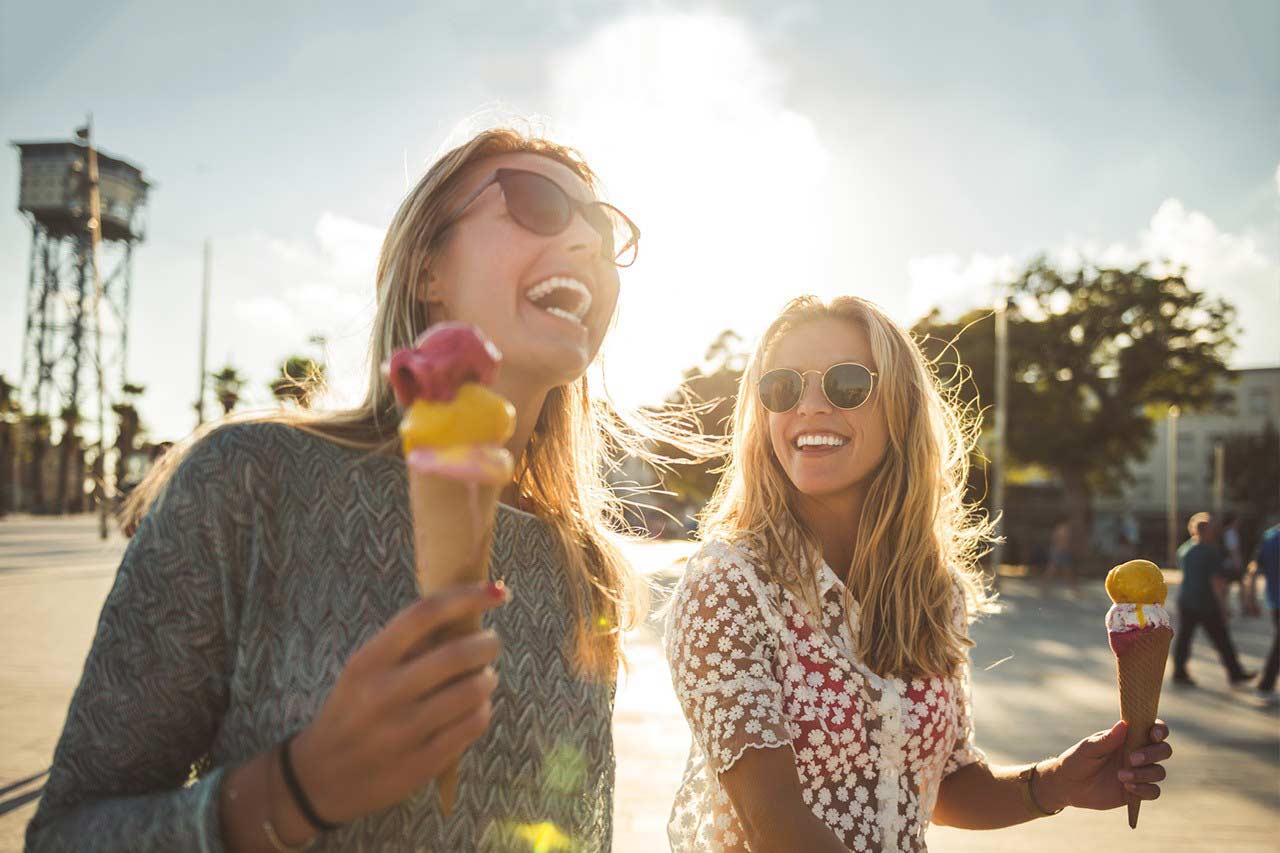 Two female friends on spring break vacation enjoying ice cream