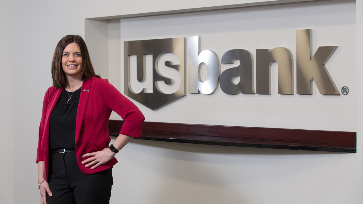 Anita Colvin standing in front of a wall with a U.S. Bank sign