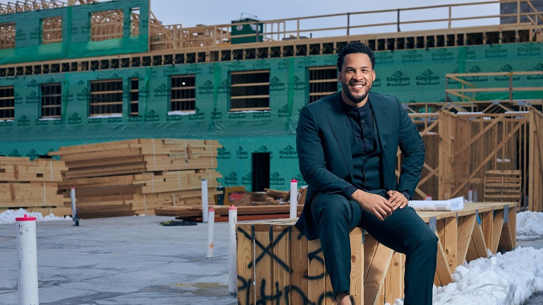 Brandon Rule poses on the roof of one of his buildings