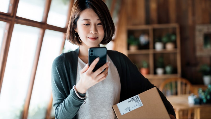 Woman using Zelle pay on her phone