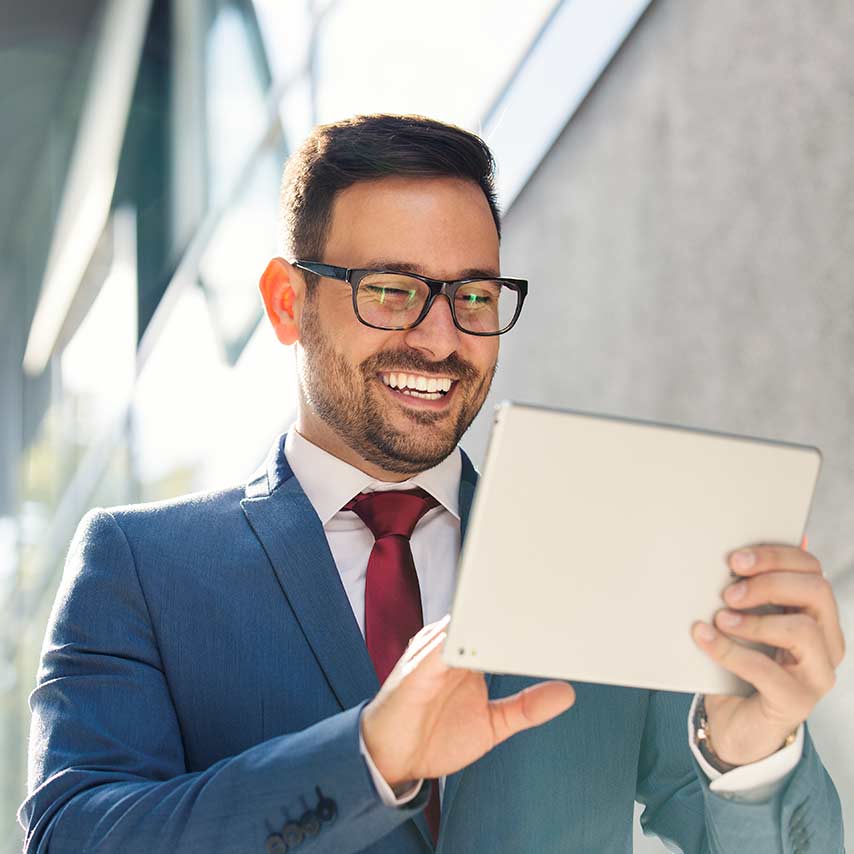 A person holding and looking at a tablet