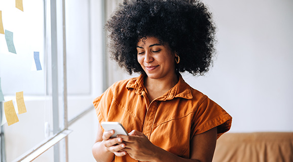 Image showing businesswoman using a smartphone in an office.