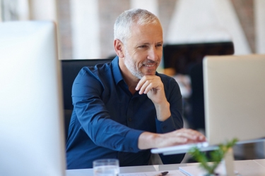 Person sitting at desk using a laptop