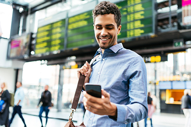 Man looking at his smartphone while traveling.