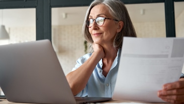 A person sitting and holding a piece of paper