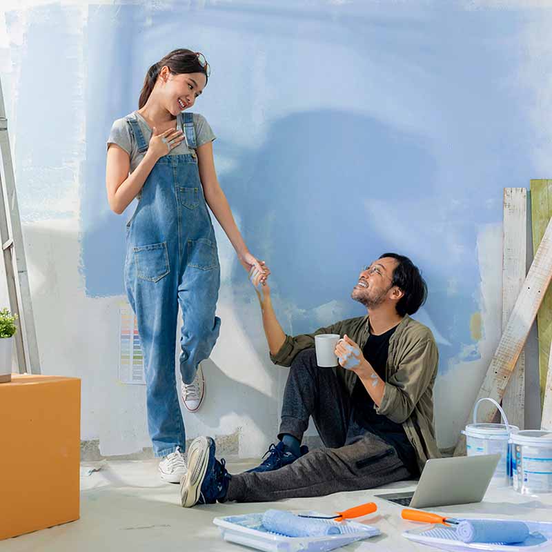 young couple painting room together