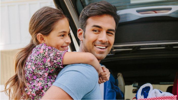 photo father giving daughter piggy back ride