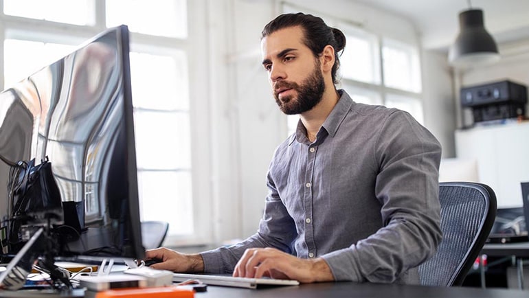 Man at a computer ordering supplies.