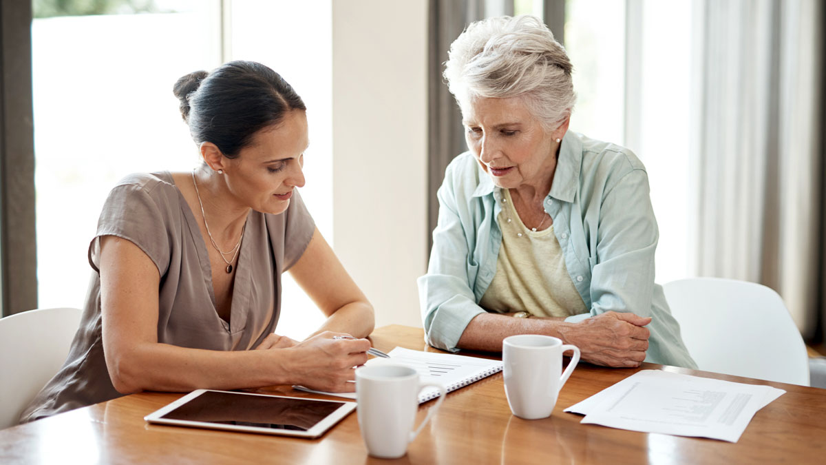 Cropped shot of a young woman assisting her elderly mother with her finances at home.