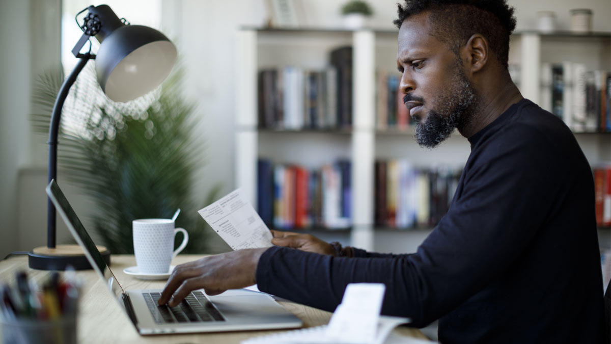 man looking at invoice